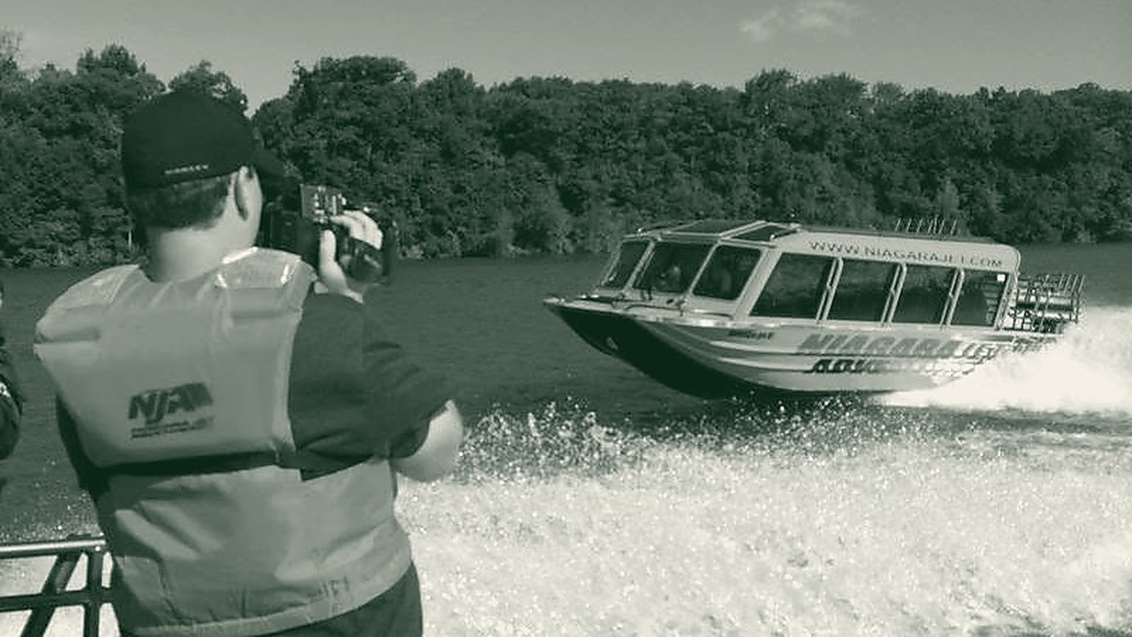 Ty Pollock filming a jet boat from the water on the Niagara River
